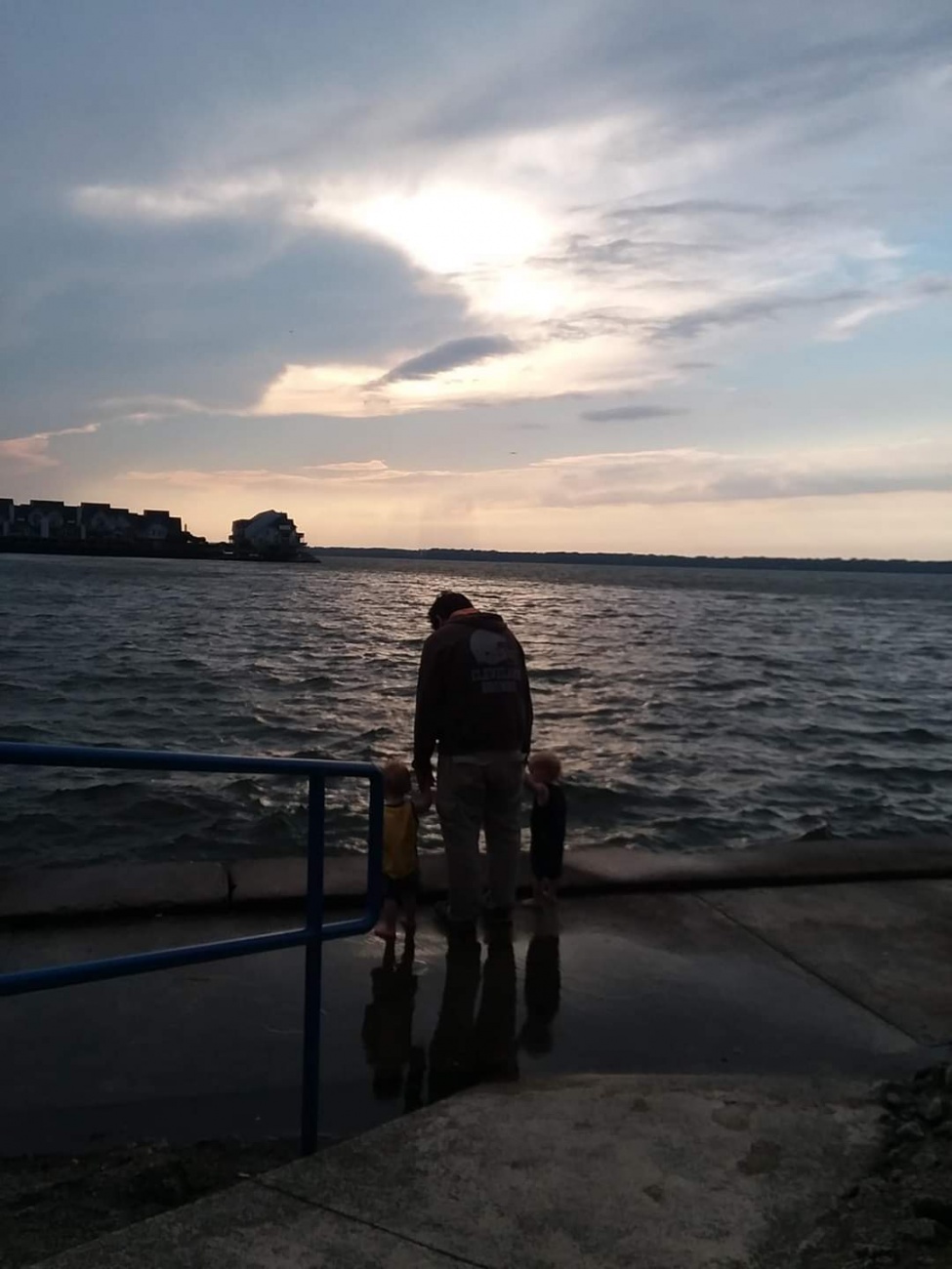 Father and sons looking at sunset